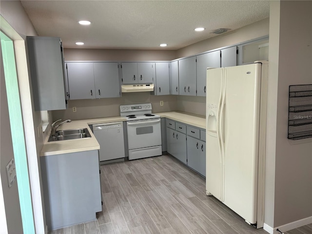 9801 SW 88th Ter Unit B, Ocala, FL 34481 - kitchen featuring white appliances, under cabinet range hood, a sink, recessed lighting, and light countertops