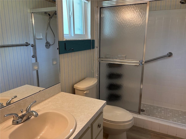 9801 SW 88th Ter Unit B, Ocala, FL 34481 - bathroom with toilet, a stall shower, vanity, wallpapered walls, and wood finished floors