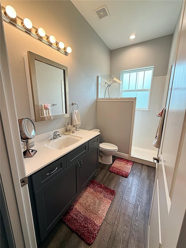 10208 SE 170th Pl, Summerfield, FL 34491 - bathroom with vanity, walk in shower, toilet, and wood finished floors