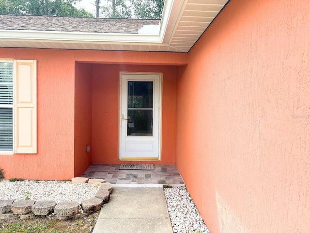 14 Dogwood Drive Radl, Ocala, FL 34472 - view of exterior entry with stucco siding and a shingled roof
