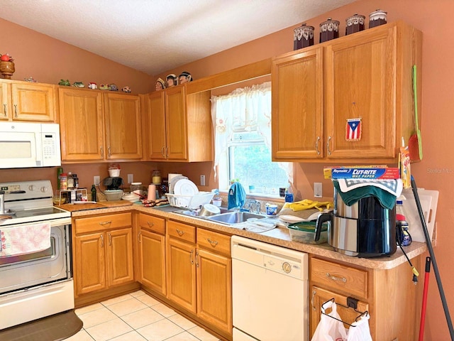14 Dogwood Drive Radl, Ocala, FL 34472 - kitchen with white appliances, vaulted ceiling, light countertops, a sink, and light tile patterned flooring