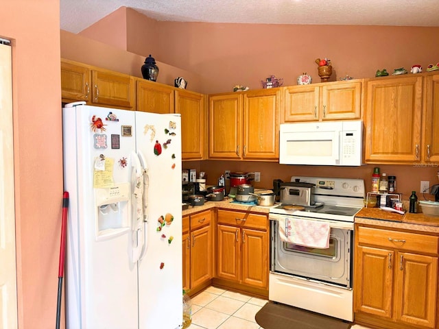 14 Dogwood Drive Radl, Ocala, FL 34472 - kitchen featuring white appliances, light tile patterned floors, light countertops, and brown cabinetry