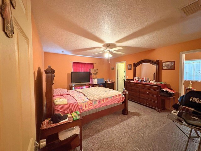 14 Dogwood Drive Radl, Ocala, FL 34472 - carpeted bedroom with a textured ceiling and a ceiling fan