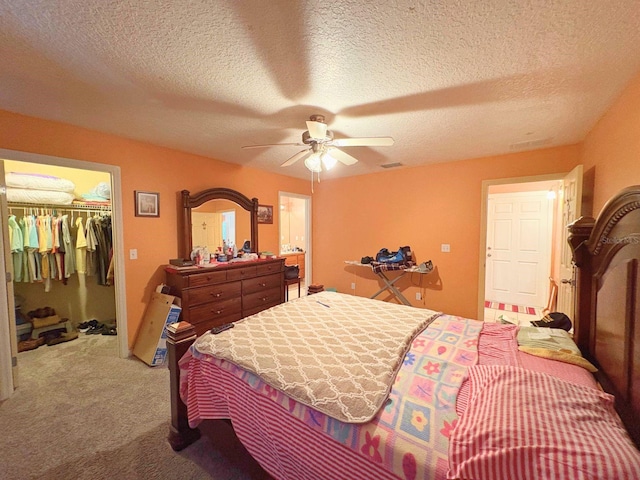 14 Dogwood Drive Radl, Ocala, FL 34472 - bedroom featuring carpet, a textured ceiling, a walk in closet, a ceiling fan, and a closet