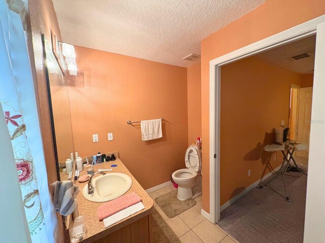 14 Dogwood Drive Radl, Ocala, FL 34472 - bathroom featuring vanity, toilet, a textured ceiling, tile patterned floors, and baseboards