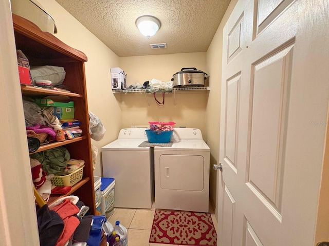 14 Dogwood Drive Radl, Ocala, FL 34472 - laundry room featuring independent washer and dryer, a textured ceiling, and light tile patterned flooring