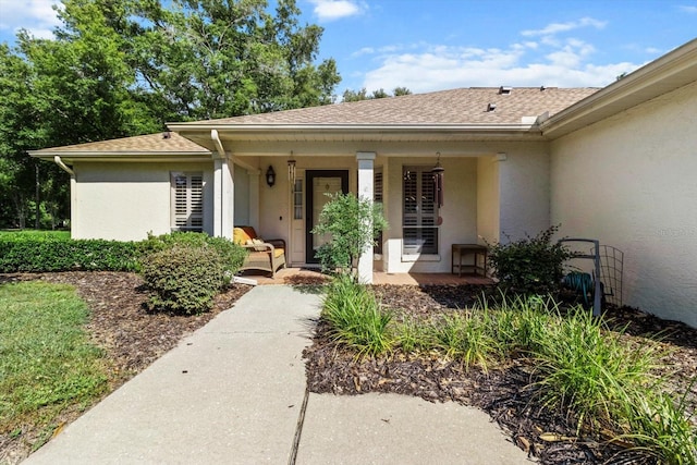 1631 W Dalary Pt Unit 1631, Crystal River, FL 34429 - doorway to property featuring stucco siding, a porch, and roof with shingles