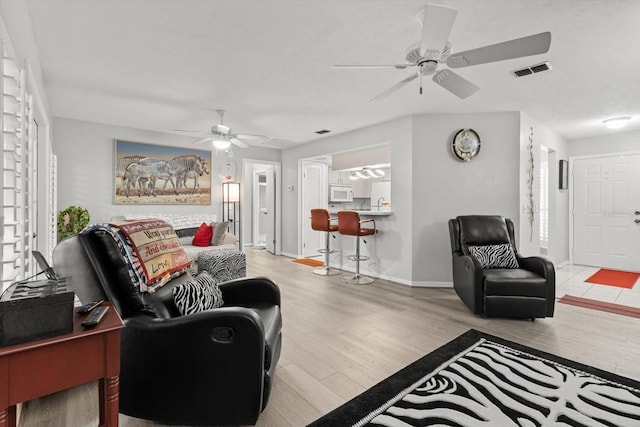 1631 W Dalary Pt Unit 1631, Crystal River, FL 34429 - living area with ceiling fan, wood finished floors, and baseboards