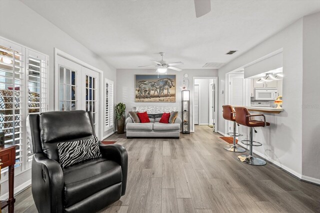 1631 W Dalary Pt Unit 1631, Crystal River, FL 34429 - living room featuring a ceiling fan, wood finished floors, and baseboards