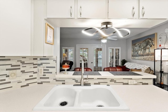 1631 W Dalary Pt Unit 1631, Crystal River, FL 34429 - kitchen featuring decorative backsplash, french doors, ceiling fan, white cabinetry, and light countertops