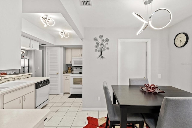 1631 W Dalary Pt Unit 1631, Crystal River, FL 34429 - kitchen with white appliances, light tile patterned flooring, a sink, white cabinets, and light countertops