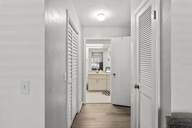1631 W Dalary Pt Unit 1631, Crystal River, FL 34429 - hallway featuring light wood-style floors, a sink, and a textured wall