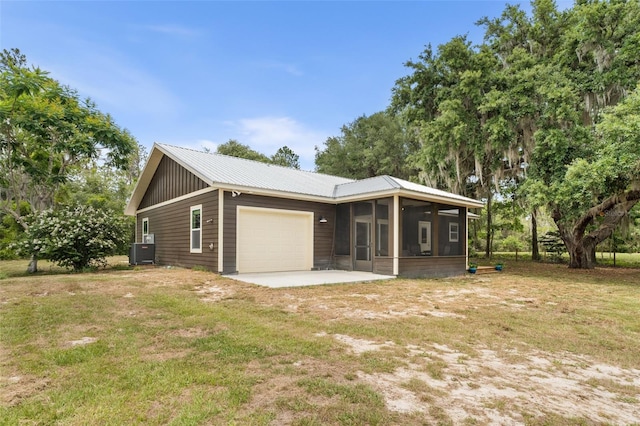 283 Riley Lake Dr, Hawthorne, FL 32640 - view of home's exterior with a sunroom, an attached garage, central air condition unit, and a yard