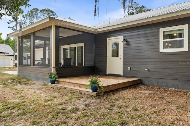 283 Riley Lake Dr, Hawthorne, FL 32640 - back of property with a sunroom, metal roof, and a deck