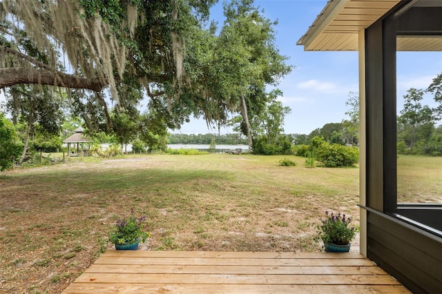 283 Riley Lake Dr, Hawthorne, FL 32640 - view of green lawn featuring a deck with water view