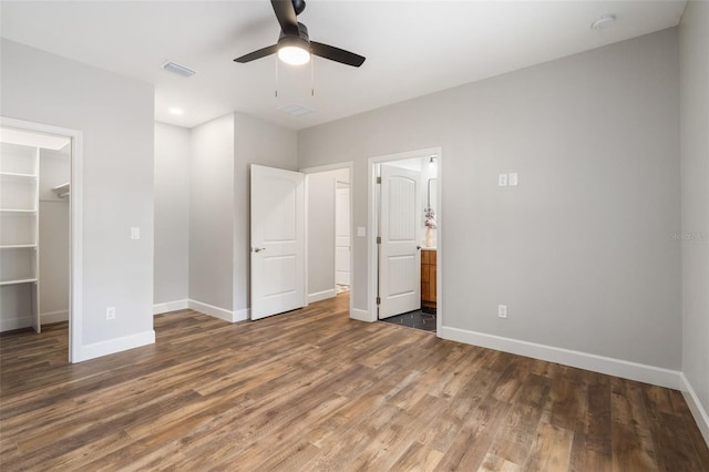 283 Riley Lake Dr, Hawthorne, FL 32640 - unfurnished bedroom with baseboards, a walk in closet, wood finished floors, and a closet