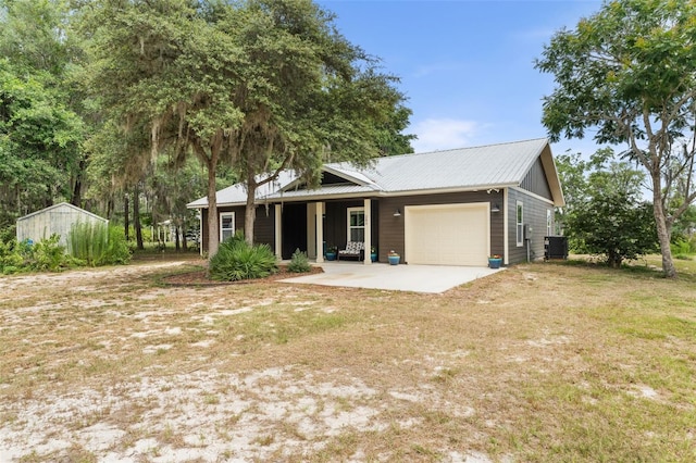 283 Riley Lake Dr, Hawthorne, FL 32640 - ranch-style home with an attached garage, central AC, dirt driveway, a front yard, and metal roof