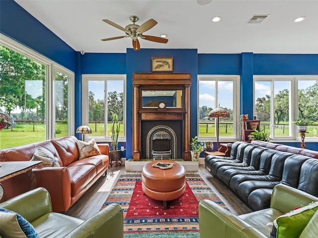 402 SW 127th Pl, Ocala, FL 34473 - living area with wood finished floors, a fireplace with raised hearth, ceiling fan, and recessed lighting
