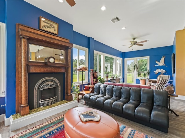 402 SW 127th Pl, Ocala, FL 34473 - living room featuring ceiling fan, a fireplace with raised hearth, wood finished floors, recessed lighting, and baseboards