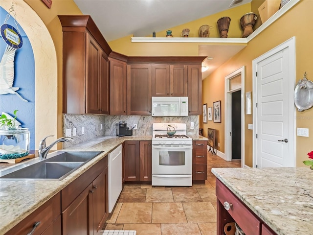 402 SW 127th Pl, Ocala, FL 34473 - kitchen featuring white appliances, a sink, tasteful backsplash, lofted ceiling, and light stone counters