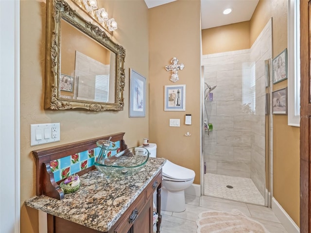 402 SW 127th Pl, Ocala, FL 34473 - bathroom with toilet, vanity, tiled shower, baseboards, and tile patterned flooring