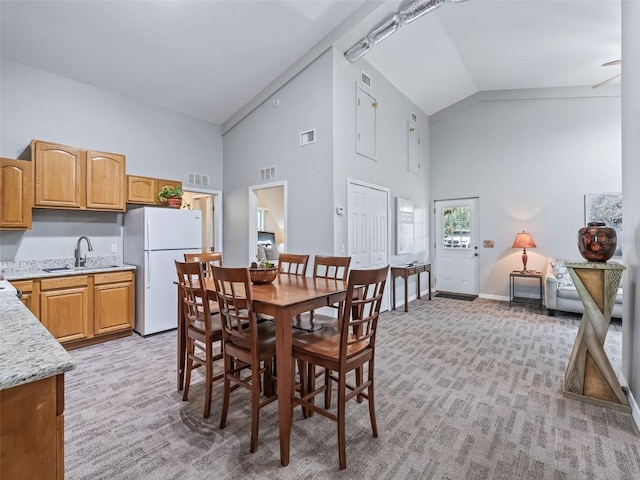 402 SW 127th Pl, Ocala, FL 34473 - dining area with high vaulted ceiling, light carpet, and baseboards