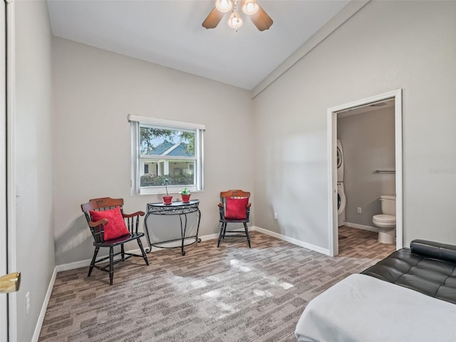402 SW 127th Pl, Ocala, FL 34473 - carpeted bedroom featuring stacked washing machine and dryer, lofted ceiling, baseboards, and ensuite bath