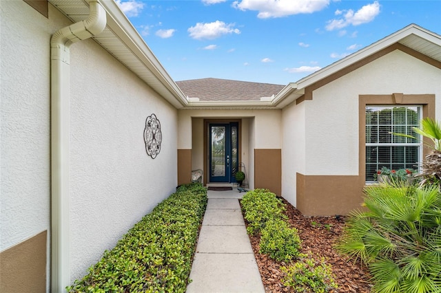 7263 SW 99th Cir, Ocala, FL 34481 - view of exterior entry with stucco siding and roof with shingles