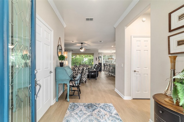 7263 SW 99th Cir, Ocala, FL 34481 - entryway with light wood finished floors, ceiling fan, baseboards, and ornamental molding
