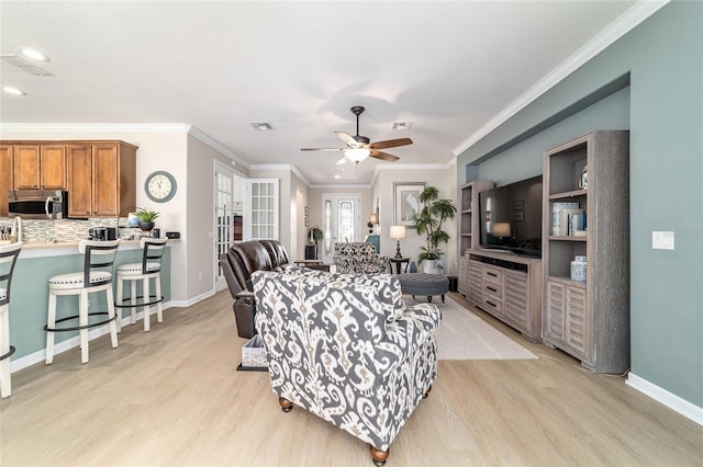 7263 SW 99th Cir, Ocala, FL 34481 - living room with light wood-style floors, a ceiling fan, baseboards, crown molding, and recessed lighting