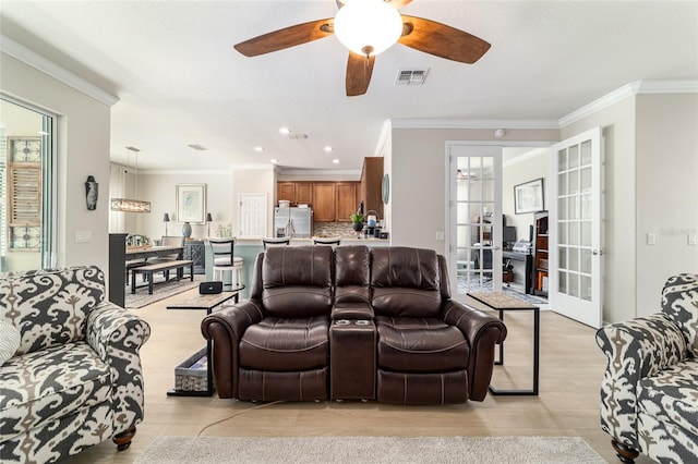 7263 SW 99th Cir, Ocala, FL 34481 - living room featuring ornamental molding, ceiling fan, french doors, light wood-style floors, and recessed lighting