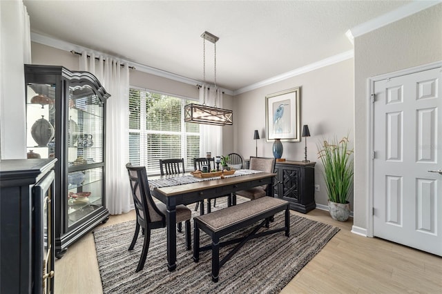 7263 SW 99th Cir, Ocala, FL 34481 - dining space with crown molding, light wood-type flooring, a chandelier, and baseboards