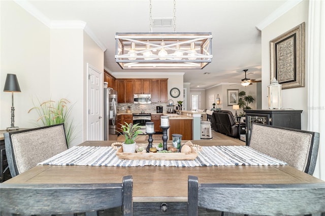 7263 SW 99th Cir, Ocala, FL 34481 - dining area featuring crown molding, a ceiling fan, and a chandelier