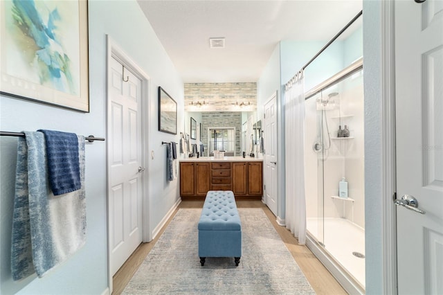 7263 SW 99th Cir, Ocala, FL 34481 - full bath featuring a shower stall, wood finished floors, and double vanity