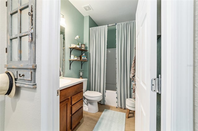 7263 SW 99th Cir, Ocala, FL 34481 - bathroom with vanity, toilet, shower / bathtub combination with curtain, and wood finished floors