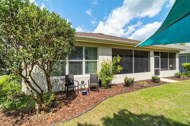 7263 SW 99th Cir, Ocala, FL 34481 - view of side of property featuring stucco siding, a yard, and a sunroom