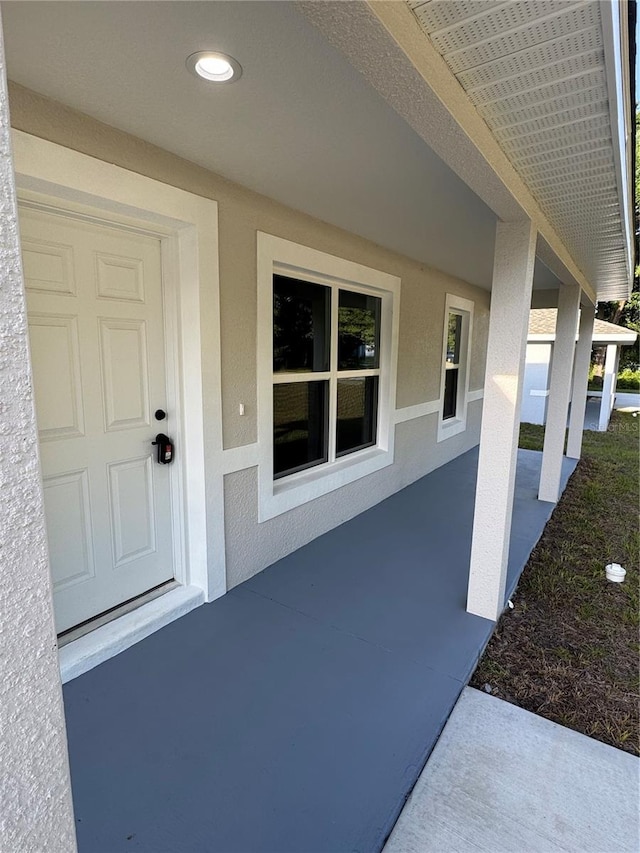 14425 SW 21st Pl, Ocala, FL 34481 - doorway to property with stucco siding and a patio area