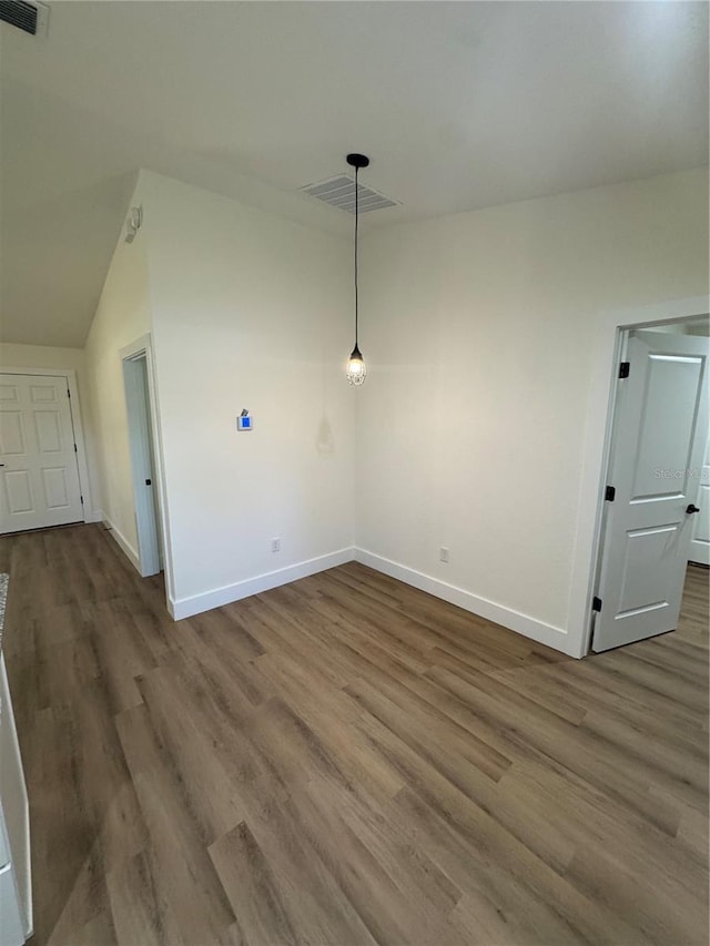 14425 SW 21st Pl, Ocala, FL 34481 - unfurnished room with baseboards, wood finished floors, and lofted ceiling