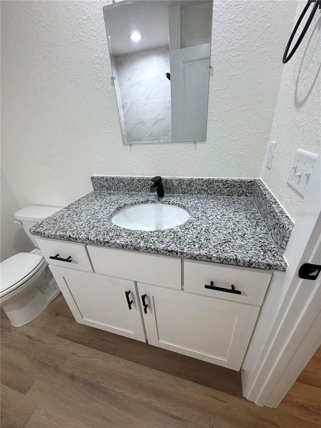 14425 SW 21st Pl, Ocala, FL 34481 - bathroom featuring vanity, a textured wall, wood finished floors, and toilet