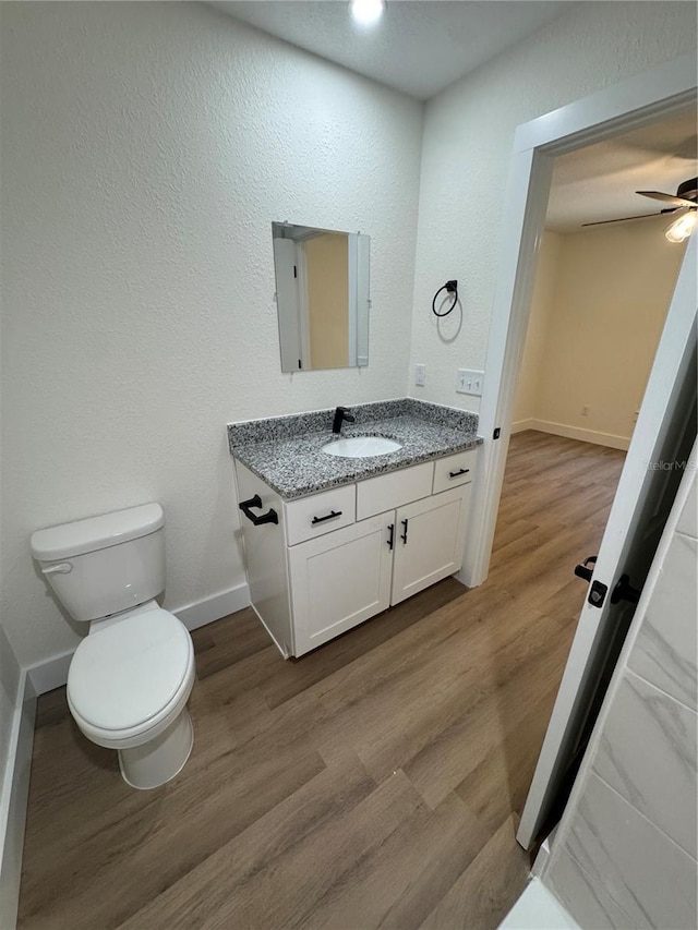 14425 SW 21st Pl, Ocala, FL 34481 - bathroom with vanity, toilet, baseboards, and wood finished floors