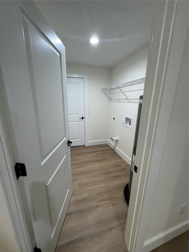 14425 SW 21st Pl, Ocala, FL 34481 - washroom featuring baseboards, washer hookup, hookup for an electric dryer, wood finished floors, and recessed lighting