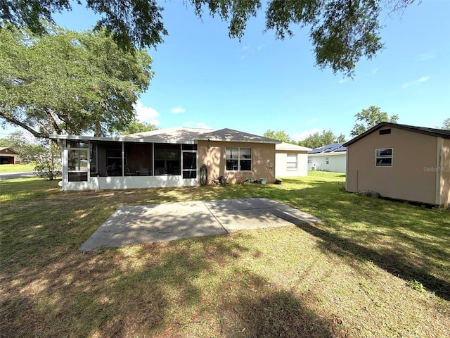 1001 NE 22nd Ave, Ocala, FL 34470 - back of property with a sunroom, a patio, a lawn, and stucco siding