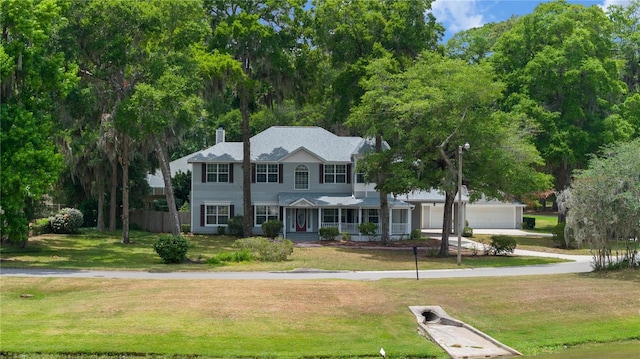 1628 SE 29th Ter, Ocala, FL 34471 - view of front of property with a porch, a chimney, and a garage