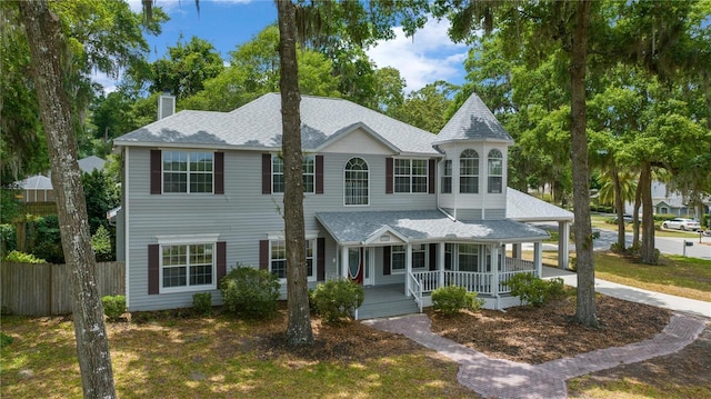 1628 SE 29th Ter, Ocala, FL 34471 - view of front of house featuring a chimney, covered porch, a shingled roof, and a carport