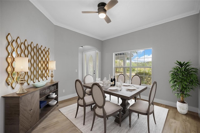 1628 SE 29th Ter, Ocala, FL 34471 - dining space featuring arched walkways, baseboards, a ceiling fan, ornamental molding, and light wood-style flooring