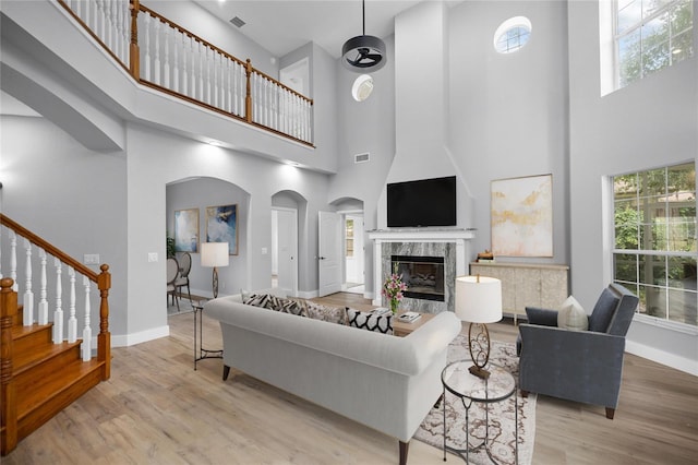 1628 SE 29th Ter, Ocala, FL 34471 - living area featuring a high ceiling, wood finished floors, stairway, and baseboards