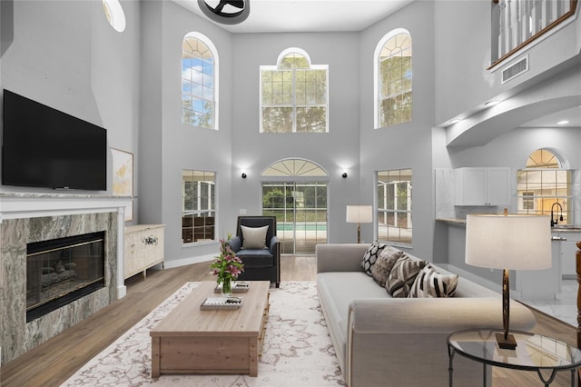 1628 SE 29th Ter, Ocala, FL 34471 - living room featuring wood finished floors, a fireplace, and a towering ceiling