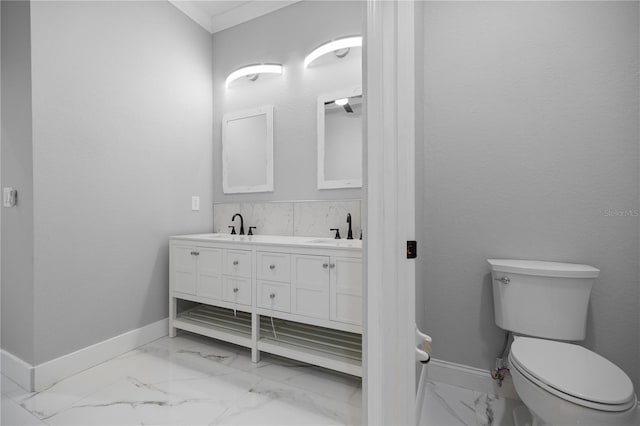1628 SE 29th Ter, Ocala, FL 34471 - bathroom featuring marble look tile flooring, baseboards, double vanity, toilet, and ornamental molding