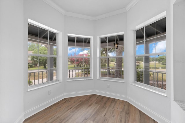 1628 SE 29th Ter, Ocala, FL 34471 - unfurnished sunroom featuring plenty of natural light, wood finished floors, crown molding, and baseboards