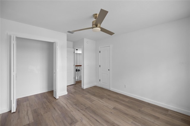 1628 SE 29th Ter, Ocala, FL 34471 - unfurnished bedroom featuring wood finished floors, baseboards, a closet, and a ceiling fan